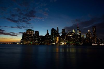 Illuminated city at waterfront