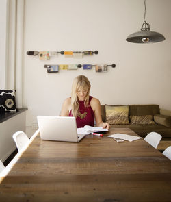 Businesswoman reading file in creative office