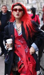 Full length of woman standing with red umbrella