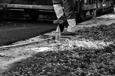 Low section of man walking on road