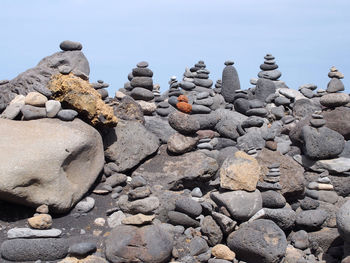 Close-up of pebbles on beach against clear sky