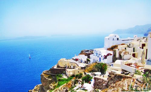 High angle view of townscape by sea against sky