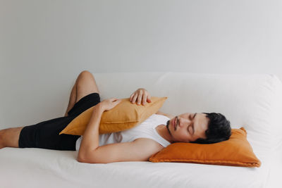 Young woman lying on bed at home