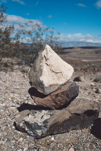 Stack of rock on landscape against sky