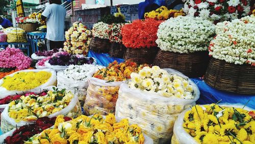 Various flowers for sale at market stall