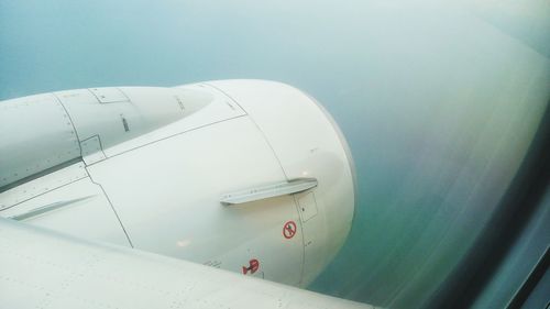 Jet engine seen through airplane window