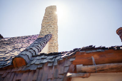 Low angle view of roof and building against sky