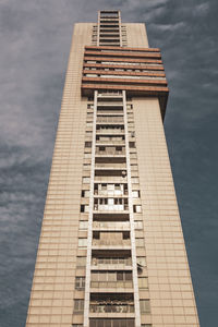 Low angle view of building against cloudy sky