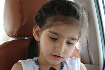 Portrait of cute girl in car