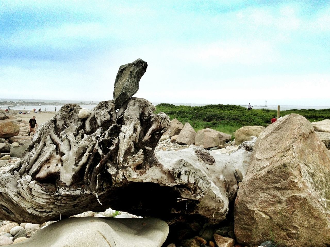 sky, tranquility, rock - object, tranquil scene, rock formation, nature, scenics, rock, beauty in nature, landscape, cloud - sky, beach, eroded, cloud, sea, remote, stone, non-urban scene, textured, day