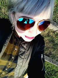 Close-up portrait of young woman in sunglasses