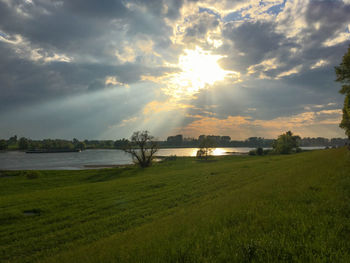 Scenic view of field against sky during sunset