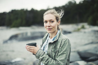 Portrait of young woman using mobile phone outdoors