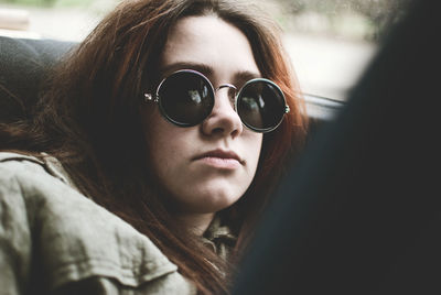 Close-up of woman wearing sunglasses in car