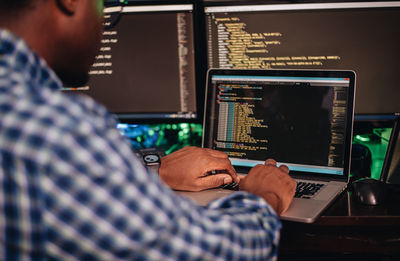 Close-up of computer programmer working at office