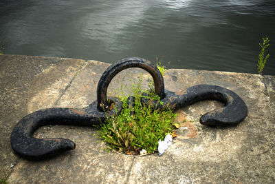 High angle view of rusty chain on lake