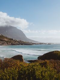Scenic view of sea and mountains against sky
