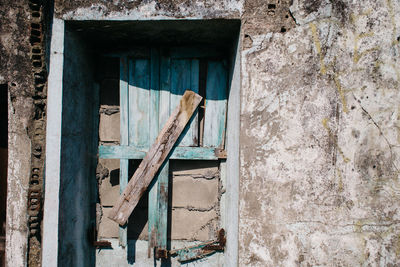 Damaged door of abandoned house