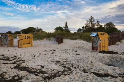 Information sign on beach against sky