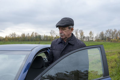 Man looking at camera while standing on land