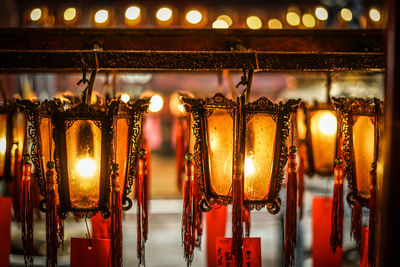 Close-up of illuminated lanterns hanging in store