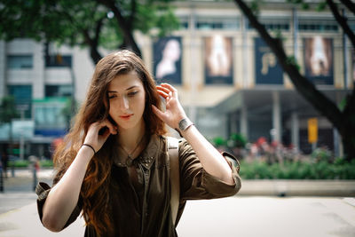 Portrait of young woman in city