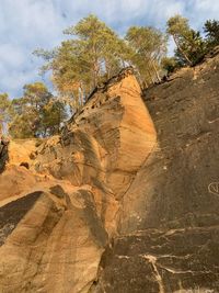 Rock formations on landscape against cloudy sky