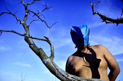 Low angle view of bare tree against blue sky