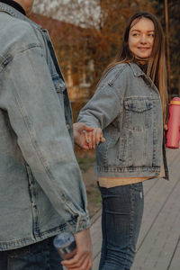 Man and a woman hold hands with bottles of water