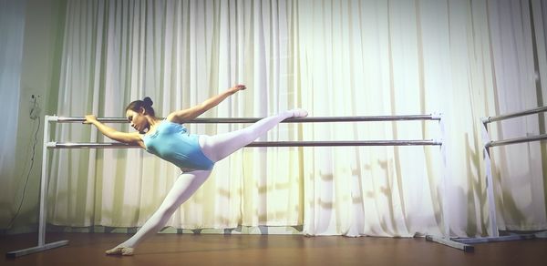 Full length of woman dancing at ballet studio