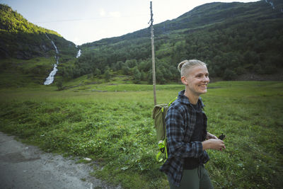 Portrait of young woman standing on mountain