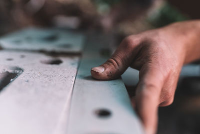 Cropped hands of man working at construction site