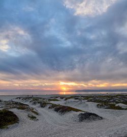 Scenic view of beach against sky during sunset