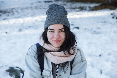 Portrait of smiling woman wearing warm clothing during winter