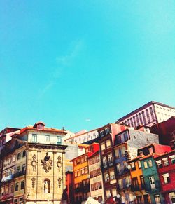 Low angle view of buildings against clear blue sky