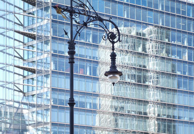 Low angle view of street light against building