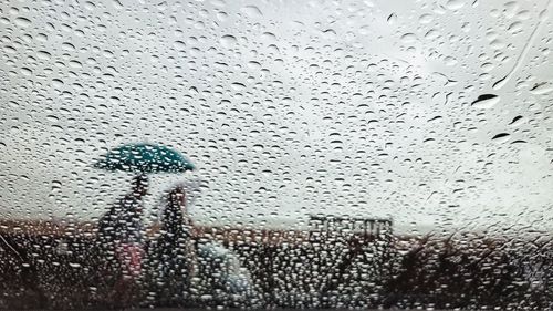 Full frame shot of wet glass window in rainy season