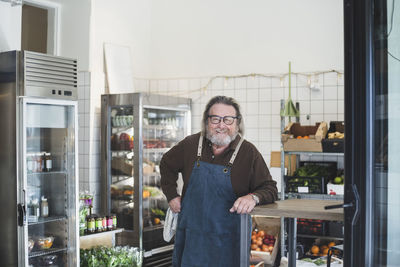 Portrait of smiling senior male owner in store