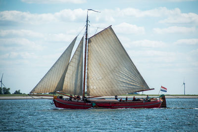 Sailboat on seascape against sky