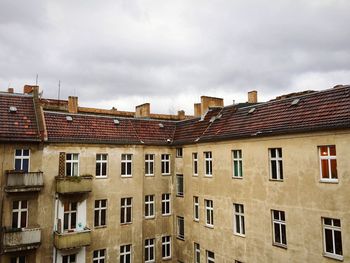 Buildings against cloudy sky