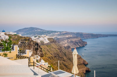 Scenic view of sea and buildings against clear sky