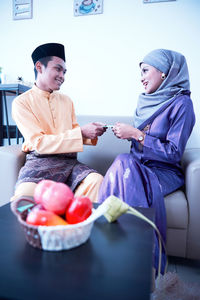 Husband and wife sharing gift during the eid festival