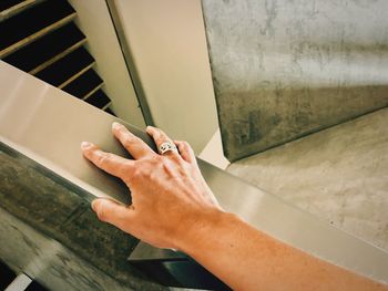 Cropped hand of woman on railing