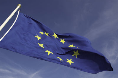 Low angle view of eu flag against blue sky