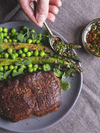 High angle view of hand holding food on table