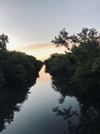 Scenic view of lake against sky at sunset