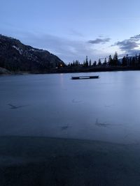 Scenic view of lake against sky during winter