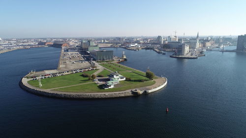 High angle view of bay and buildings against sky