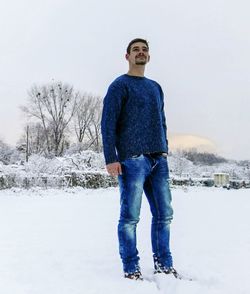 Woman standing on snow covered field