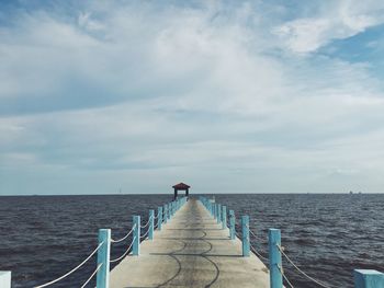 Pier over sea against sky